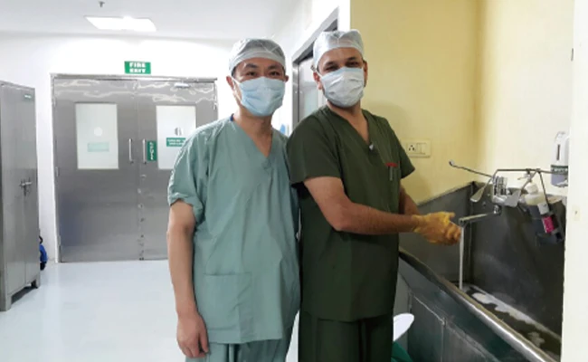 Director Choi — surgical training at Apollo Hospitals, India, supervised by Dr. Rajesh Fogla